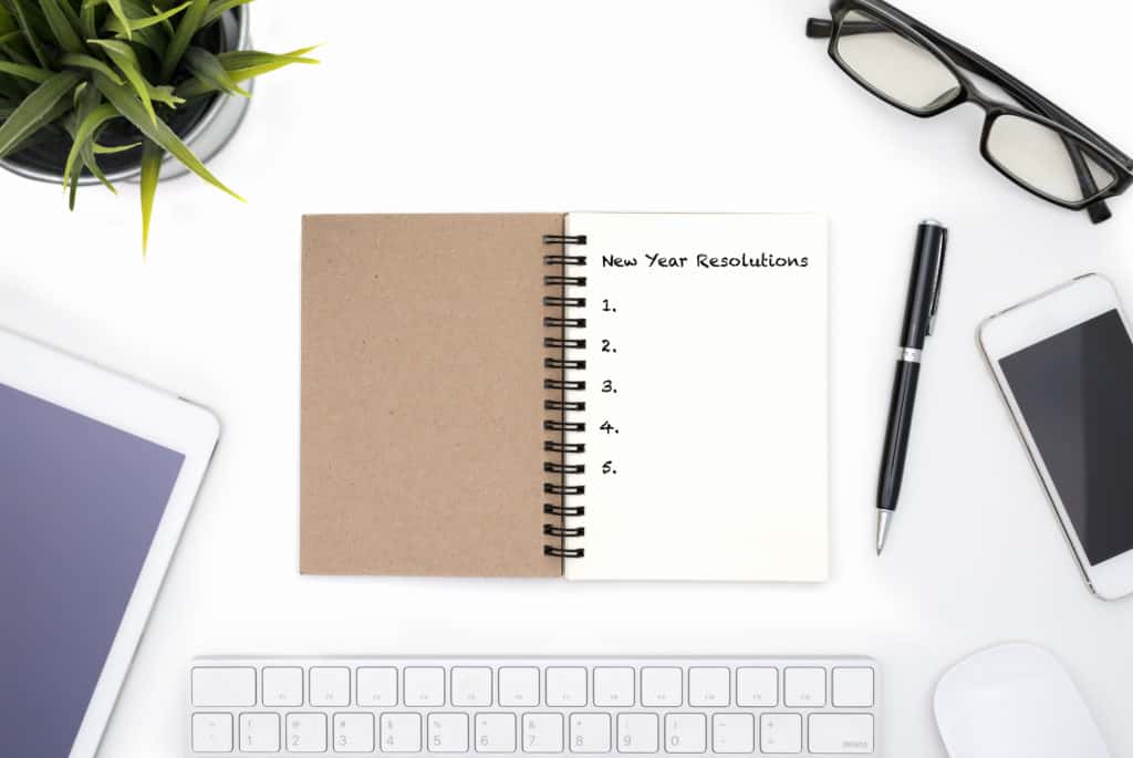 New year resolutions notebook on a white desk